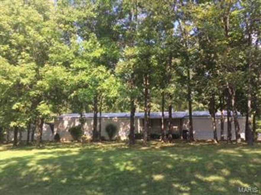 Escape to this 3 bedroom/2 bath home on 6.4 acres in a beautiful park like setting with mature trees.  Relax on the covered front porch or the large (12 x 20) screened-in back porch and enjoy privacy, nature, fresh air, wildlife and quiet.  The BBQ area has a stone patio and gazebo.  Inside features a divided bedroom floor plan with new carpeting installed in the bedrooms in August.  The living room has a beautiful corner fireplace.  Other features include ceiling fans, kitchen island with breakfast bar, new dishwasher in 2015, refrigerator in 2014, hot water heater replaced 2017, and central air in 2015.  A Fire Chief wood stove in the shed outside adds efficiency and warmth in the winter.  Two other outbuildings with electric (10x20 and 15x20) give you plenty space for your toys, storage and/or workshop.  Don't miss out on this great opportunity to own a quiet place in the country!  Come check it out today!