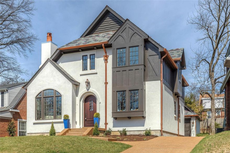 Period Restoration presents this stunning new Tudor home which blends perfectly within its University Hills neighborhood. Inspired by historic Maritz & Young architecture, you’ll appreciate the 20’ vaulted living room with hand-hewn beams, a limestone fireplace and expansive arched windows. The main floor master suite is light-filled and stylish with picture molding walls, a window seat and a spacious walk-in closet. The master bath is resplendent in Carrara marble accents with dual vanities and herring bone flooring. The kitchen features custom cabinetry, Carrara marble counters, apron front sink, center island, custom pantry, Miele & Wolf appliances and a breakfast area. Hand-forged iron handrails lead you upstairs to three bedrooms, two full bathrooms and a balcony overlooking the grand living room. The finished lower level hosts a slate floor recreation room with a custom wet bar and full bathroom. The finest building in materials and appointments are sure to impress!