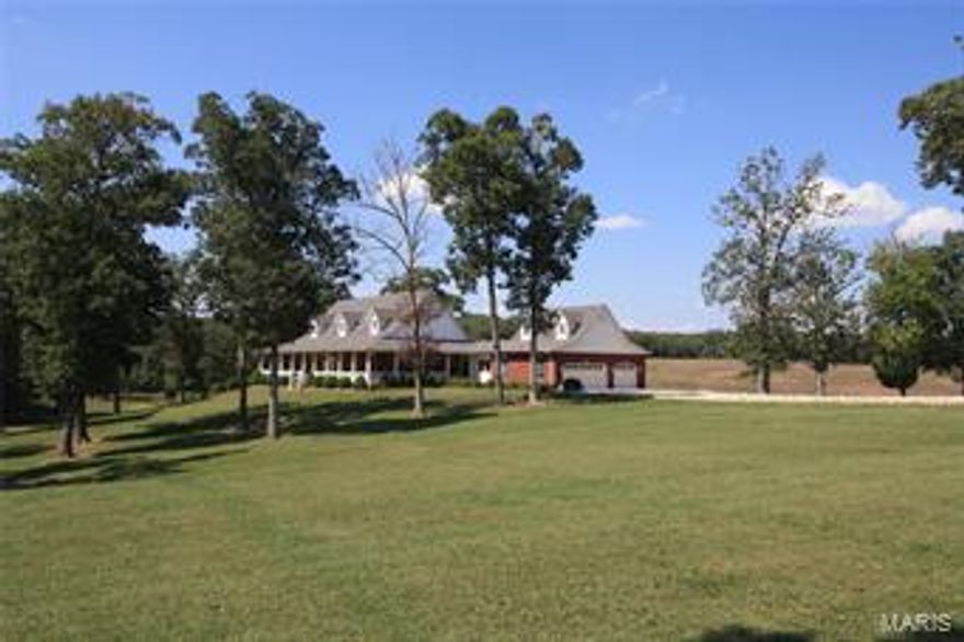 Custom brick/Vinyl home with nearly 5,000 sq ft. & 80 acres of pasture & woods. 4 bedrooms, 3.5 baths & attached over sized 3 car garage. Home has full finished walk out basement, wrap around porch. Oak flooring, ceramic tile flooring & carpet in master bedroom. Vaulted ceilings with oak beams, large wood burning fireplace w/ rock hearth, tray ceiling in master bedroom, large kitchen w/ corian counter tops w/ built in sink, custom pantry and bay window that overlooks the property. Total wrap around porch w/ concrete composite decking. Rubber coated chain link fence for dogs. Master bath has large glass walk in shower w/ jets on shower walls, Jacuzzi tub with dual sinks. Built in entertainment cabinet, oak panels line the stairway, vaulted ceiling in formal dining room. 40x48 horse barn with 4 stalls, bathroom, tack room, wash bay. 48x48 shop with 12x48 apartment with 1 bedroom & 1 bath. 60x100  Hay Barn, welded cattle pins, 2 hydrants, concrete working chute, live creek & pastures.