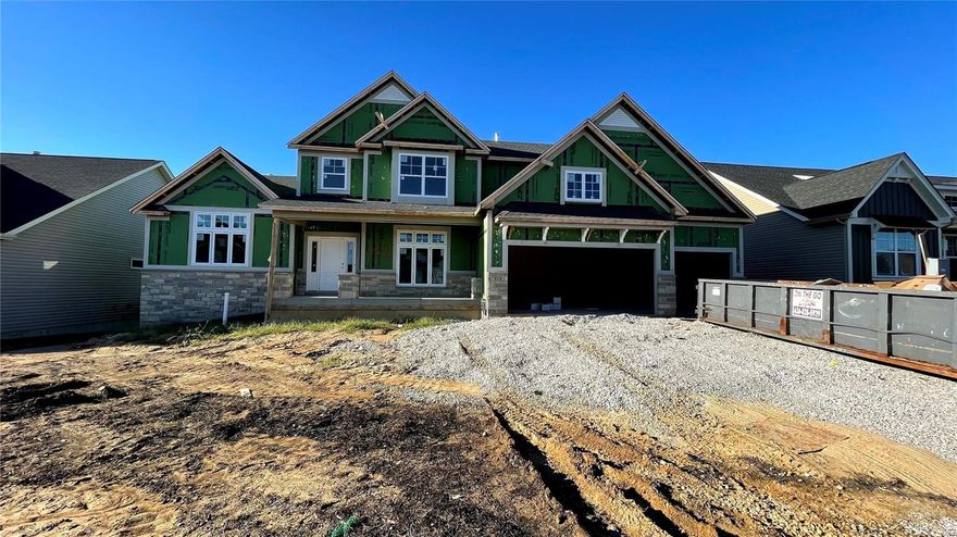 Welcome to this rare opportunity to buy a Newly Constructed 1.5 Story Home on a walk-out lot, without waiting for a year or more to complete the process. The Sandfort Farm Community features a community pool and green spaces of common ground in this sought-after location just inside St Charles County along I-70.  Approx. 3,500 sqft of Finished above grade living space featuring Main Floor Laundry, Formal Dining, Main Floor Owner's Suite with Luxury Bath and Free Standing Soaking Tub, with Luxury Engineered Hardwood throughout the main level.  Upgrades abound from the Quartz Countertops throughout the Expansive Kitchen and Island to the Luxury Cabinets, Gas-Cooktop, Built-in Oven and Microwave Wall, Pre-plumbed water line for a refrigerator, and upgraded lighting.  Enjoy the 11 Foot Ceiling Height in the Great Room, See-thru Fireplace, Floating Bookshelves, and more. This home will be completed this Fall and is just awaiting its new owner to move into this never-lived-in Home.