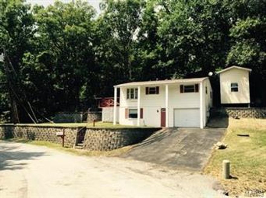 **READY FOR THIS ONE**  Step into this "Ready To Move In" 3 Bedroom House with an amazing private patio and deck made for entertaining.  Surrounded mostly by woods, you will feel like you're on a permanent getaway.  With the 1 ½ story work shop and its over-sized 1 car garage, you have room for all your hobbies and still have plenty storage space.  The 2 driveways allow for plenty of extra parking for Cars, Boats, RV's, etc...  Updates include New furnace, New electric panel, New carpet, New double hung Tilt Bay Windows, and Newer roof.  House was transferred to Public Sewer.  Hard wood floors, Ceramic Tile, Private Deck and Patio, Backs to woods, Private street, Public Water, Gas Stove, Central Air, Cable Ready, Freshly painted inside and out.  Six panel doors throughout.  Crown molding, Gas and electric hookups  available for dryer, Streets are county maintained, No Subdivision dues.  Hurry....This one won't last long!