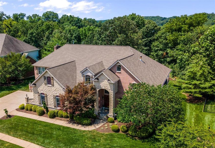 Impressive 5 bedroom, 1.5 story home in the Wings of Eagle Crest! Over 7000 finished sq ft of luxury space on a one acre lot backing to trees. Two-story entry foyer with elegant marble flooring is flanked by the study with French doors & built-ins and the formal dining room featuring a tray ceiling. The great room boasts an 18-ft ceiling, Palladian windows and double-sided gas fireplace. The kitchen has been recently updated with quartz counters, subway tile backsplash, new lighting, fresh paint and more. Main floor master suite offers 12-ft ceiling, bay window and sitting room with a fireplace. The upper level features three spacious bedrooms and a bonus room. A fantastic finished lower level awaits with rec room, exercise room, extraordinary wine cellar/wet bar, stone flooring, double-sided stone fireplace and fifth bedroom with a spacious full bath that would be great as in-law or teen suite. Composite deck overlooks the wooded yard boasting an award winning waterfall & pond.