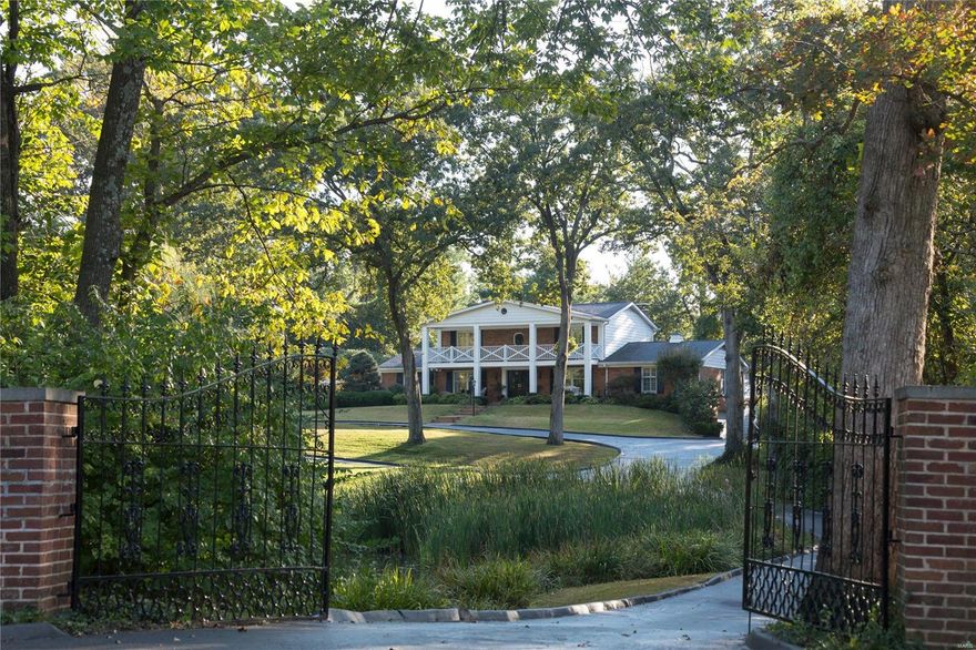 A country lifestyle on 3 rolling acres in centrally located Village of Huntleigh. A long gated drive leads to a gracious 2-story Southern Colonial home with pool, comprised of 5,000+ square feet of living space with 5 bedrooms and 5 baths. A hearth room addition features coffered ceiling, wet bar, fireplace and herringbone floors. The updated kitchen and breakfast room overlook saltwater pool and patio. Wolf, Viking, SubZero, and Bosch appliances. Main level master suite with walk-in closet and luxe bath. 2nd level hosts 4 bedrooms and 2 full baths. Two bedrooms open to the portico's balcony. Finished Lower level with card and billiard areas, complete with sauna and full bath. 3 Car garage. Private pond attracts heron, geese, and other wildlife for a parklike setting. Lighted tennis court, conveyed as-is; refurbish or transform turned into sport court, pool house or Barn, as property is Equestrian. Adjacent to Plaza Frontenac, restaurants, shops and the new Lifestyle Center.