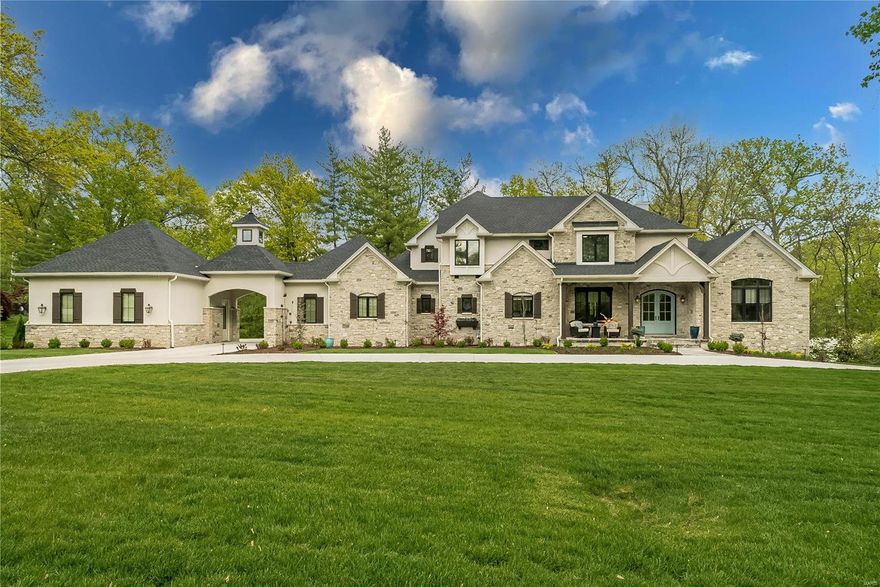 Price Improvement! Enjoy new construction in Ladue School District without the wait! This spectacular newly-completed McKelvey-home combines elegant design & the best of luxury details. The open floorplan is flooded with natural light and centers around a stunning great room with vaulted ceiling & Juliet balcony. With 10' ceilings & hardwood floors throughout, the main level includes an impressive office, gourmet kitchen, enviable hearth room, butler's bar, laundry, mudroom & more. The primary bedroom suite is a true retreat, with a 12' tray ceiling, spa-like bath with zero-entry shower, soaking tub & heated floors. There are 3 bedrooms upstairs, and 5th bedroom suite, bonus/workout room & large rec room complete the walkout lower level. A jaw-dropping screened porch with phantom screens & gas fireplace overlooks the lush, private 1-acre yard. A picturesque porte-cochere connects two oversized garages with four bays and electrical vehicle charger. Truly an estate not to be missed!