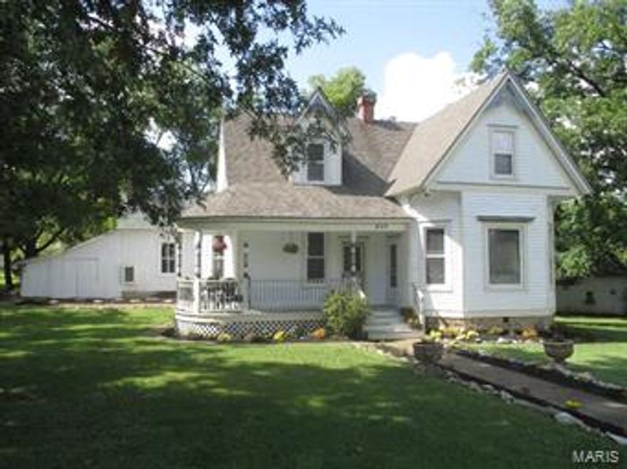 Step into this beautifully appointed grand Victorian style home on 4 shaded city lots-character galore-formal dining room with original millwork-coffered ceilings in several rooms -living room with bay windows & spiral staircase-4 bdrms 2 baths, approx. 2300 sq ft.-main floor master suite with electric fireplace-10 ft ceilings-all new handscraped hardwood floors and new carpet in bedrooms-MFL-Alterna tile floors in kitchen-large covered back deck-wrap around porch-smoke house great for storage plus garage-1 year home warranty-call for full list of details/updates-there is laundry hook up in master bath as well-with full price offer seller will provide $1500 allowance to buyers to help with any upgrades or modification they would like to do. August 2016, new middle school will be opening.  Please verify correct middle school for the address with the school district.  Do boundary search at www.troy.k12.mo.us or call central office