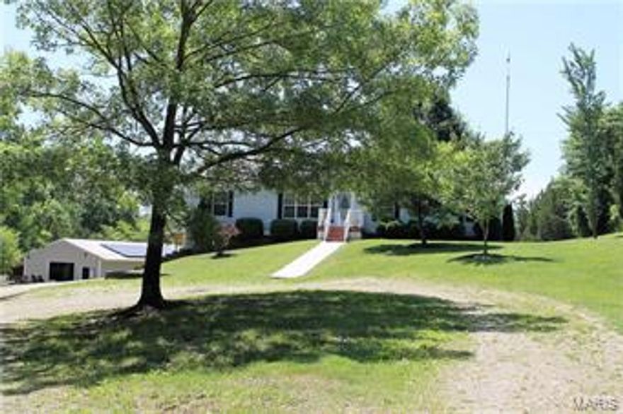 Pristine 3 bedroom ranch amongst a magnificent 21 acre setting and an additional 1500+ sq. foot building with endless possibilities*The car enthusiast, the boater, the collector, workshop, potential barn-electric and 2 oversized doors at both ends*Roll down the scenic lane to view this lovely home with great curb appeal*Enter find an open Great Room with wood floor, wood burning fireplace flowing to Dining Room with wood floor*Yummy kitchen has tons of cabinets, wood floor, granite, nice GE appliances, newer stainless refrigerator, slider door to large composite deck*Split bedroom design with Master suite offering walk in closet & luxury bath w/ceramic tile floor, soaking tub, sep. shower*Additional BRs 2/3 with full bath*Main floor laundry/mud rm, crown molding thru out main floor, boiler added for enhanced heat source, solar panels on house & out building, neutral décor*Mostly fenced property w/a combination of flat grassy area & woods*Truly a special home that should not be missed! Additional Rooms: Mud Room