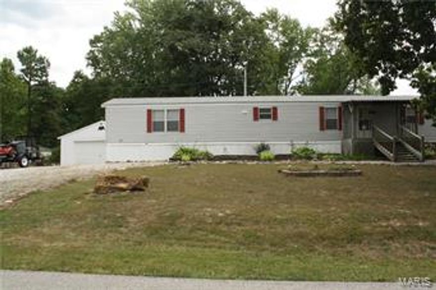 3 bed 2 bath mobile home on .65 acres!  Large kitchen with tons of cabinet space, center island and peninsula.  Bonus - the refrigerator, washer & dryer stay!  New roof in May, 35 year shingles. Security system. Dining area next to sliding glass door that leads to back deck overlooking nice level yard with privacy fence.  Living area has a cozy woodburning fireplace to relax by.  Master bedroom features master bath with garden tub & double bowl vanity.  11x11 shed and 24x26 metal building featuring concrete floors, electric, overhead lighting & wood burning stove.