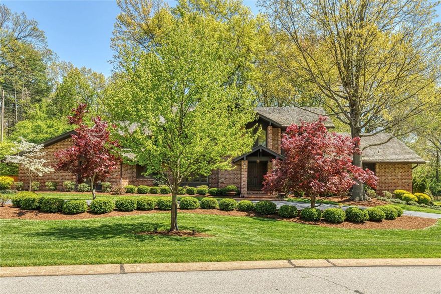 Spectacular brick contemporary in premier Town & Country location. This custom-designed 1.5 Sty features vaulted ceilings, elaborate millwork, plantation shutters & oak hardwoods that extend throughout the main floor. Impressive 2-sty foyer highlighted by dramatic curved staircase leads to formal dining room & library-paneled study with built-in bookcase. Beamed cathedral ceilings & floor-to-ceiling brick fireplaces set the tone for the stunning living room & adjacent family room. Newly designed kitchen with white Shaker cabinetry, marble countertops, commercial grade appliances & 12' center island adjoins breakfast room with wide bay windows. Coffered master bedroom suite offers an appealing retreat with customized walk-in closet & luxury bath with Jacuzzi.  3 Additional bedrooms with ensuite baths plus a 4th bedroom & bath with private entrance complete the 2nd floor living quarters. Situated on an impeccably landscaped 1.4-acre lot with brick terraces, circular drive & 3-car garage.