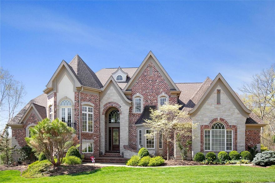 **NEW PRICE*** Marvel at this magnificent 1.5 story home on a serene yet accessible 2.47-acre lot! This 6800 sq ft home boasts an open and light filled floor plan. The grand foyer features custom archways, an open staircase and gorgeous lighting.  The 20 ft great rm with custom millwork and FP captures the surrounding views by scores of windows.  The stunning open kitchen/breakfast/hearth room features granite countertops, SS Dacor/Subzero appliances. The separate dining room features coffered ceiling and elegant lighting. Main floor master suite has 2 walk-in closets, tub and shower. The 2nd floor offers an office, 3 beds and 2 full baths. The walk-out LL, is an entertainer’s dream: state-of-the-art media room, game area, custom bar w/square icemaker, dishwasher, TRUE refrigerator/cooler, oversized bath, and wine cellar w/cigar humidor. Add'l features: main floor laundry, whole home surround sound by Sonance, and exercise room.  This home is centrally located and is truly spectacular!