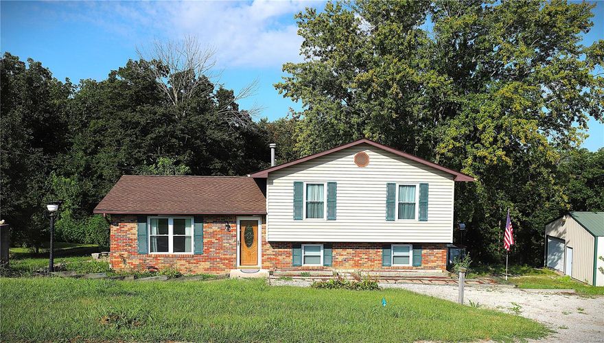 Welcome HOME. This home is multi-level with plenty of space for your family. It sits on an acre and a half that boasts apple, peach and plum trees. The inside welcomes you to a large living room that opens up to an eat-in kitchen for your family gatherings. The upper level has a full bath and three large bedrooms. The lower level is a walk-out that is partially finished with a great recreational area or family room. This home has been well loved with updates to the upper-level bath to include a walk-in shower, some new flooring, new roof, newer windows, water heater and HVAC system. On the property, you will also find a 30x24 shop that is insulated, has electric, concrete flooring and additional storage space in the attic. There is also a space inside the shop that was used for making/storing wine. There is an additional outbuilding giving you even more storage! This home is ready for YOU to add your personal touch and spend many evenings on the patio overlooking the gorgeous yard!
