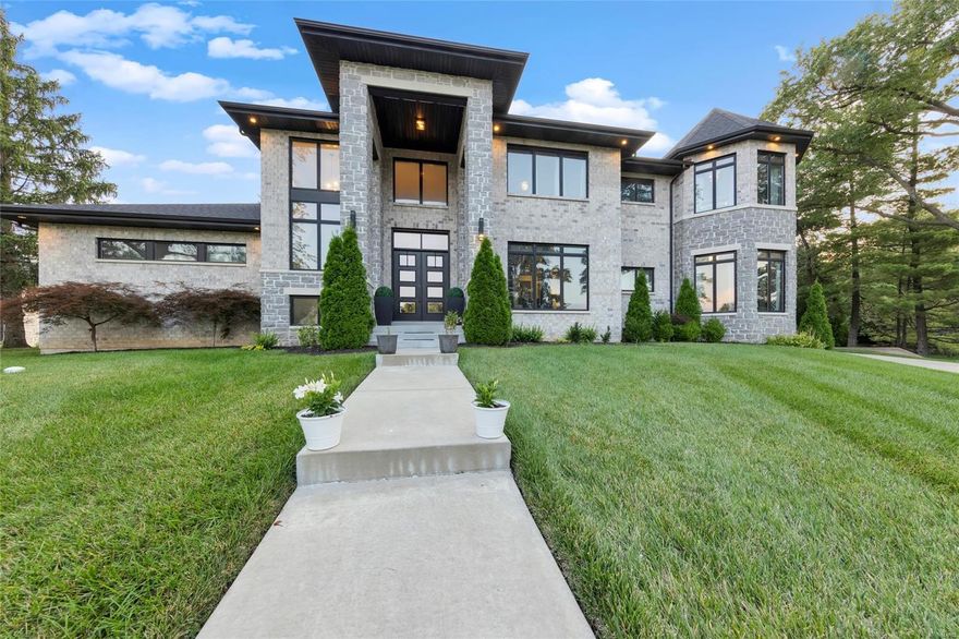 Welcome to 74 Berkshire Dr—a stunning luxury listing that epitomizes elegance and sophistication. Located in beautiful Richmond Heights and the highly rated Ladue School District, this 5-bedroom, 5-bathroom estate spans 4,561 sq ft of meticulously designed living space, offering the ultimate in comfort and style. Step into a grand foyer that leads to expansive open concept living areas adorned with high-end finishes, built-in shelving and custom updates. The gourmet kitchen features top-of-the-line appliances, center island breakfast bar and seamless integration into the grand dining and living spaces. The opulent main floor primary suite is a sanctuary, boasting a spa-like ensuite bath and walk-in shower, with an additional main floor mother in law suite down the hall. Each additional bedroom and bath is thoughtfully designed to provide the utmost in privacy and comfort. Outside, the professionally landscaped grounds create the perfect setting for serene evenings or lavish gatherings. Additional Rooms: Mud Room COOL: 14 SEER+