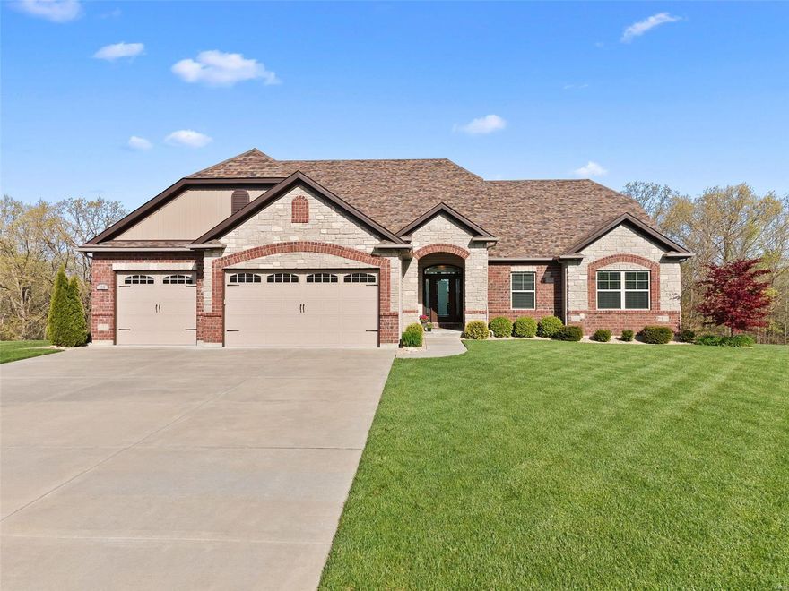 This gorgeous estate on 2.1 acres in Troy has all the PRIVACY you crave & all the CUSTOM FINISHES you crave! Beautiful rich hardwood floors greet you upon entry & carry through the open floor plan. The soaring 11' ceilings in the great room features a wall of windows with BREATHTAKING views overlooking the lake & cozy brick & stone gas fireplace! The exquisite chef's kitchen will dazzle w/ SS appliances, stunning tile backsplash, & 42" soft-close shaker cabinets. The center island breakfast bar w/ gorgeous granite countertops invites you to enjoy your morning coffee. The peaceful & serene backyard deck is the ideal place to host family & friends for summer evening cookouts! Relax & unwind in your luxurious master suite with walk-in closet & spa-like bath boasting dual sinks, whirlpool tub & amazing doorless tile walk-in shower. Finished walkout lower level w/ bedroom, full bath, spacious rec room & 2nd living area for entertaining! Oversized 3 Car garage. Lush landscaping! A MUST SEE!