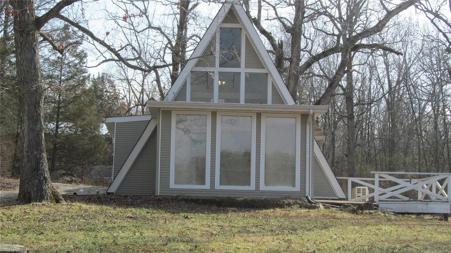 Beautiful remodeled A-Frame sits on 2 Lots located at Indian Hills Lake just in time to enjoy Spring/summer. This 2 bedroom and loft bedroom with gorgeous pine wood from top to bottom in living room area. Kitchen has new appliances and new flooring throughout with carpet, laminate and tile. Mini split heating & cooling  for super efficiency. Like new 21 x 25 detached garage with concrete floors and electric that will hold your vehicle and lake toys. Good location with lake view call today to preview this property. Additional Rooms: Sun Room