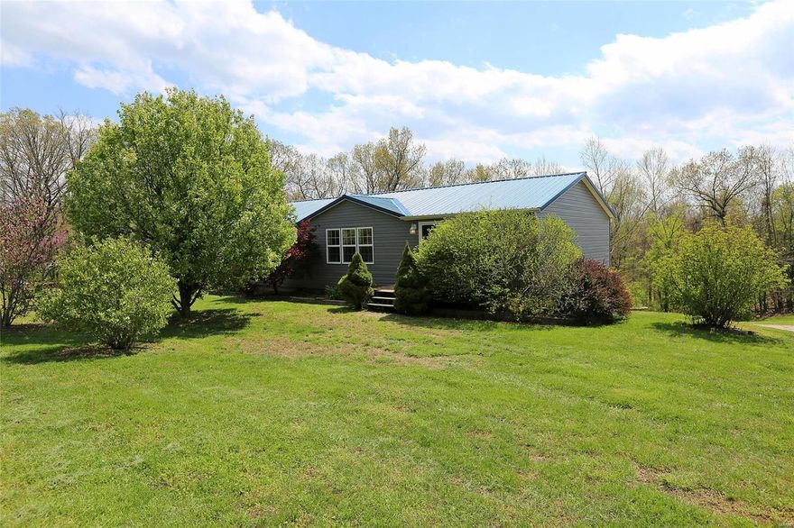 3BR/3BA MOVE-IN-READY RANCH ON 4 ACRES! Country living just 7 minutes off of Hwy 21! Enter to living room w/3 large windows, electric fireplace w/mantle, & vaulted ceiling that extends over entire main level! Kitchen boasts white cabinets & white appliances (refrigerator stays!), 2 ceiling fans, ceramic tile floor, & HUGE center island that seats 6. Sliding glass door leads to covered deck w/ceiling fan--enjoy the peaceful view of large back yard that backs to woods. Back inside, handy utility room is adjacent to kitchen--washer/dryer both stay! Main floor master is roomy & boasts large walk-in closet & private bath w/dual sinks. Two more bedrooms & a hall bath round out the main level. Walk-out lower level provides addt'l living areas--kids will love the 27x16 family room w/direct access to backyard & covered concrete patio, plus a 25x25 rec-room w/adjacent 15x8 wet bar/kitchen area, 3rd full bath, & 14x9 workshop. Large shed & kids' clubhouse with full electric both stay!