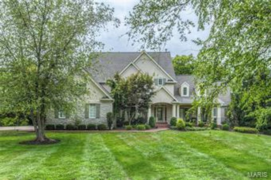 This one is truly too pretty for words.  Current owner has added on to the house expanding the hearth room which enlarges the whole kitchen side of home to include an extra finished room in lower level.  Therefore tax records on sq feet are incorrect.  Built by Fischer and Fritchel this home sits on a lovely private lot backing to trees, with the golf course beyond that.  Professionally decorated with beautiful appointments and special touches throughout.  First floor master suite with large customized closet and glamour bath, Two story great room with wall of window to rear  and walk behind wet bar, Fabulous kitchen with large center island, stainless appliances, custom cabinetry and granite, Beautiful wide plank hickory flooring runs through 90% of first floor. Upstairs there are 3 additional bedrooms and 2 full baths.  Lower level is a walk out with large family room, billiards room, walk behind wet bar,  exercise room, hobby room, bedroom and full bath. 3 fireplaces.  3 car garage.