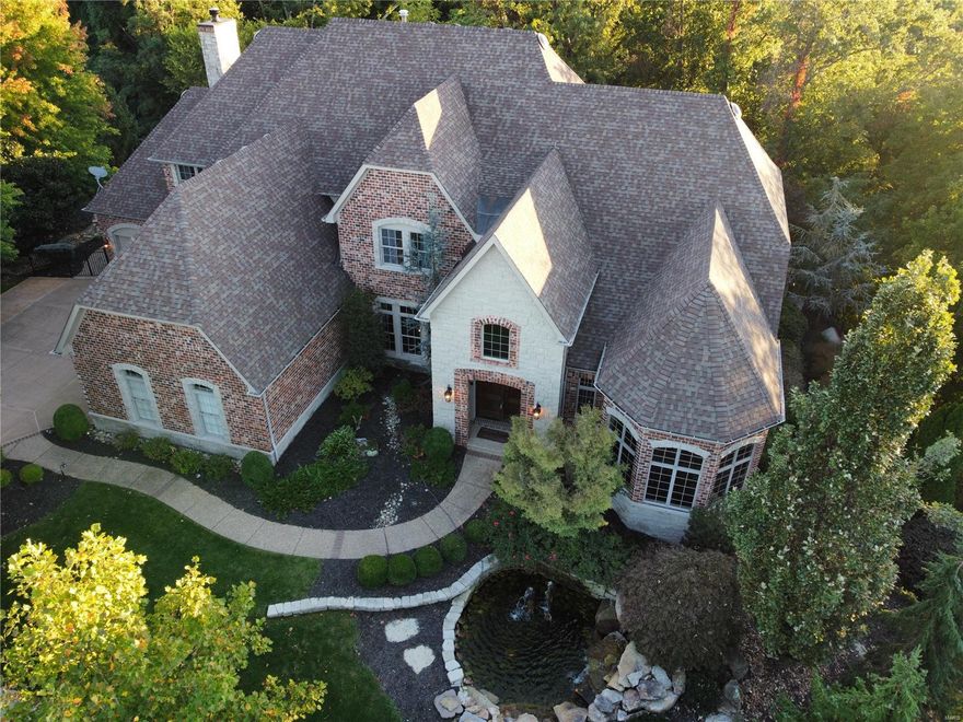 Incredible 1.5 story Estate home w/ many recent updates on 1.4 acre grounds! Situated in a gated enclave of custom-built homes. Grand 2-sty foyer leads to paneled library with 12’ ceiling, bay window & built-in bookcases, coffered dining room with elaborate molding & butler’s pantry and spectacular great room with fireplace and wall of windows w/ private wooded views. State-of-the-art kitchen w/ cherry cabinetry, granite counters, & center island adjoins sunny breakfast room & hearth room highlighted by stone fireplace. Luxurious MBR with coffered ceiling, fireplace, bay window & luxury bath. The 2nd floor includes 3 large BR’s, 1 with private bath & 2 with Jack n Jill bath, + bonus room with custom built-ins. Walk-out LL with family room, media room, wine cellar, rec room, 2nd kitchen, exercise room and bath w/ spa & 2nd laundry. Gorgeous grounds include pond w/ fountain, veranda, 3-season room, patio w/ fireplace, infinity pool, hot tub, playground & 4-car garage with storage system Additional Rooms: Wine Cellar