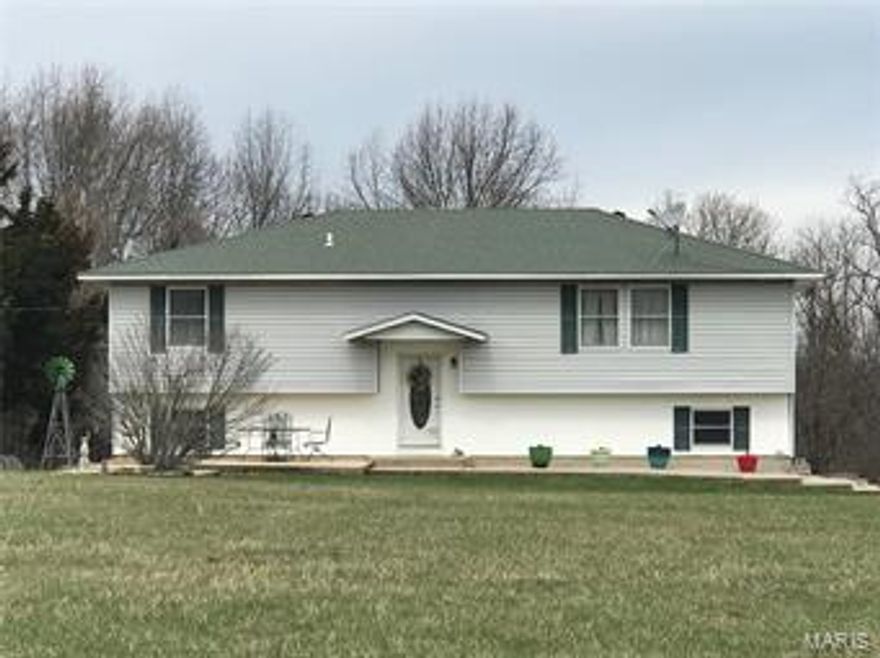 BACK ON MARKET, NO FAULT OF SELLERS! PRICED TO SELL!!!! Beautiful 4 Bedroom, 3 Bath Home on 31+ acres with detached garage/ outbuilding and pond. This is not your average split-Level home. It has a large open floor plan with 3 spacious bedrooms and a partially finished walkout basement doubling the square footage of the upstairs level. The eat in kitchen has a breakfast bar and dining area leading out the deck overlooking the peaceful park like view, You will find gorgeous newer laminate flooring throughout the living room, hallway and upstairs bedrooms. Entertain guest in your finished family room downstairs or BBQ on the front or back patio while the kids run around and play. This could be your very own personal country paradise so act now before it is too late!!