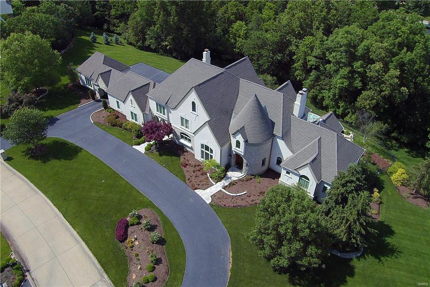 OPEN HOUSE CANCELLED - PENDING SALE. Stunning Johnson Dev. custom 1.5 sty in Town and Country's premier Lochinvar community of 7 spectacular homes.
Enter the private gated subdivision,notice the 2nd home on the left with stone and stucco construction is a real "eye catcher" with double wide circle driveway, porta cache leading to 5 car garage,lush landscaping and resort style pool w. waterfall feature & hot tub. Upon entering the front door you will realize the elegance, charm and attention to detail that embraces this "dream home" Over 8000 s.f.,2 sty great rm limestone flooring, elegant barrell ceiling dining rm. a "nothing missing" 2 of everything kitchen, 4 huge ensuite bedrooms w. walk-in closets, 8 bathrms, 3 masonry f pls., laundry rms on all 3 levels, awesome finished lower level w. "cheers" bar, media area w. huge screen, workout room, billiard room, cedar closet, 1.5  baths (1 w. dressing rm/1 with steam shower) and a golf putting room. Additional Rooms: Mud Room