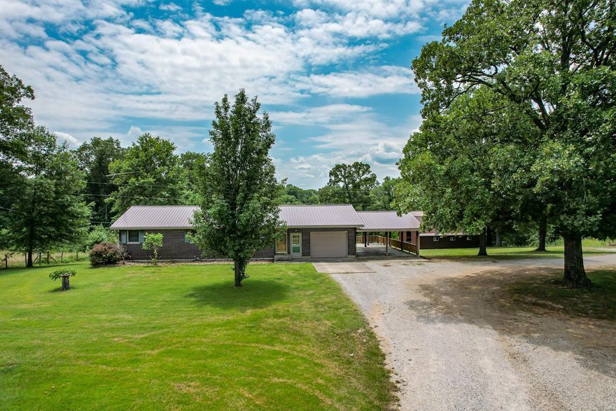 Located just minutes from town with an abundance of privacy sits this 3-bedroom, 2 full bath home. Featuring a large kitchen/dining room combo, beautiful fireplace in the living room, remodeled full bathroom, and three bedrooms on the main level makes this home move in ready.  The walk out basement is partially finished with a full bathroom and with a little TLC this basement could almost double your living space. There are laundry hook ups in the garage, as well as the basement. The property features two outbuildings. one is a 26x36 finished shop with a half bathroom and three bay attached pole barn for additional equipment storage. If you wish to start a mini farm there is a livestock barn on the property as well with stalls and a tool room. This home will be sold with approximately 10 acres, the home will be surveyed off a larger tract prior to closing. This property is what everyone is looking for so don't miss out on your opportunity to purchase a home with land.