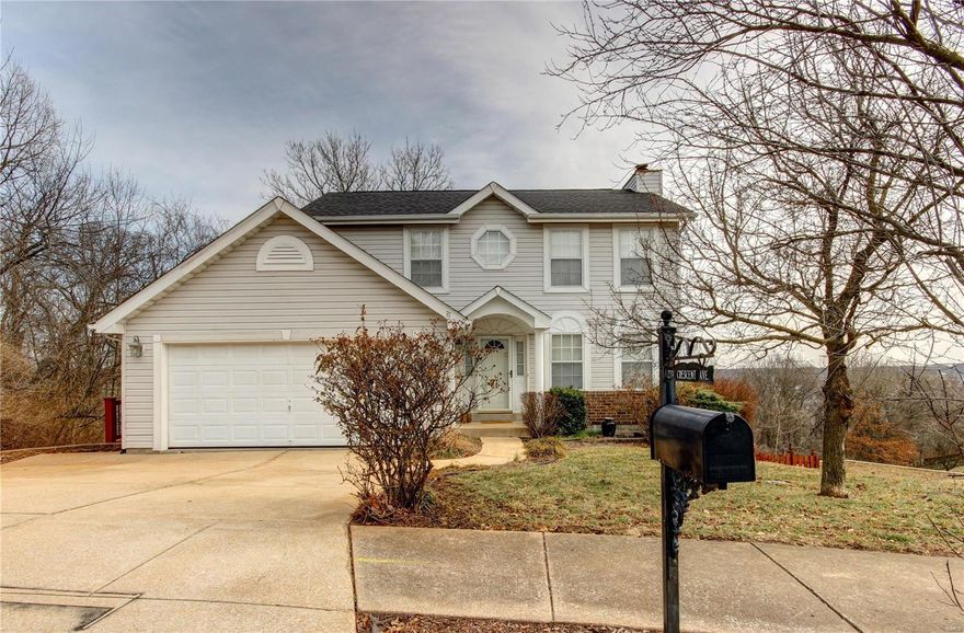 Welcome to this lovely two-story in Valley Park! You'll immediately notice the curb appeal with great landscaping! Enter to the open layout of the living room and dining room that's perfect for entertaining and features a cozy woodburning fireplace and crown molding that continues throughout the home. The kitchen has hardwood floors, a breakfast room, and bay window that leads to the deck with a stunning view! Upstairs, the large master bedroom has an en-suite bathroom with pedestal sink, wainscoting, and step-in shower. Two more spacious bedrooms and a bathroom complete the space. The finished basement is a show-stopper with a stone bar, hardwoods, and custom lighting! Walk out to the paver patio and impressive two-tiered deck that overlooks the fenced yard that slopes to woods. Just moments from Twin Oaks Park, restaurants, shopping, highways, and in award-winning Valley Park schools, this home is one you won't want to miss!