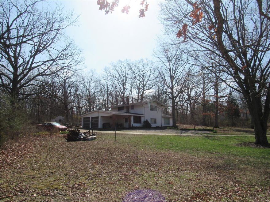 OPPORTUNITY this home is located in Oak Grove Village on 14.5 acres. This means it has access to public utilities!! The home needs some TLC, and the grounds need some cleaning up. BUT there is room to divide the woods into 3 - 4 acre lots... Hummmmm.
So you can build homes for the family, or your dream home nestled in the woods. Renovate the house for rental or to suit your needs.  The first floor has 2 bedrooms, upstairs is a complete 1 bedroom apartment. So you can spruce up for in-law suite, or live above your business???  The address is E Springfield BUT it is also Historic Route 66. You could have the home and road front rezoned for a business... OH, the possibilities! Located a mile from Hwy 44 and all the conveniences Sullivan has to offer.