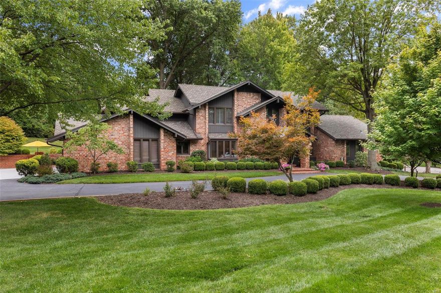 Can a home be both glamorous and inviting, comfortable AND dramatic? This 1 ½ story hits the perfect note! Nestled on a meticulous treed and private lot, the glass paned entrance door opens to the light filled 2 story entry with herringbone hardwood, custom staircase and trim flanked by crisp wainscoting and millwork. Sparkling wood floors grace the first level including the prior living room now a billiard club room with built-ins and dual wine storage and the adjacent richly paneled library. White kitchen with marble counters, large wood island, Subzero and designer appliances opens to a cathedral vaulted great room with large windows overlooking the spectacular wooded setting and brick patios. Magnificent main floor Primary bedroom suite with newer marble appointed bath. Four large bedrooms upstairs with four full baths. Main floor laundry, three car garage. This home glistens with quality and updates!