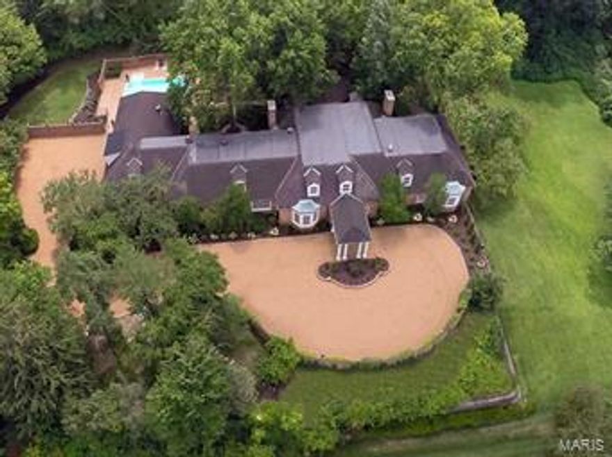 This exquisite, 8133 sq ft, 5 bedroom, 8 bath manse is a newly-renovated classic. 
Exclusive 2-acre estate, nestled on a private lane adjacent to St. Louis Country Club, with its manicured gardens, secluded pool and cabana it is the ideal place to relax in style. Entry foyer view takes your breath away as you walk into one of three formal sitting rooms: living room, gallery with 25’ glass ceiling & library with hardwood floors, each with gas fireplace–perfect for entertaining. As you enter double doors of the main floor master suite, discover an inviting sitting room with 4th fireplace, his & hers bathrooms & walk-in dressing room. Formal dining room leads to state-of-the-art kitchen, with custom wood cabinetry, granite counter tops, Wolf/Sub-Zero/Viking appliances & main-floor laundry. Upstairs includes 3 additional bedrooms, 2 en suite baths, family room and a fifth suite with separate entrance from the 4-car garage–great for nanny or home office.