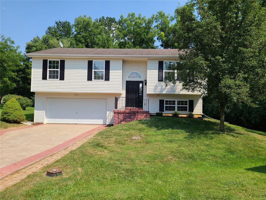 If "Lake Living" is your style, you will definitely want to check out this wonderful home. *Move-In Ready* with all the *Lake St. Louis Amenities*, fresh paint, vinyl plank flooring plus a new A/C and water heater in 2021.  The cul-de-sac location backs to trees/common ground, giving you a peaceful, private oasis on the 12x12 deck. This home boasts an open floor plan and cathedral ceilings giving this home that spacious, luxurious feeling. The finished lower level walk-out basement offers a family room and 3rd full bathroom to give you the perfect amount of entertaining space. The oversized 2-car garage allows you plenty of storage and work space. The refrigerator, washer and dryer may be negotiated. The LSL Community Association includes access to 2 lakes, clubhouse, pool, tennis courts, fitness center and golf. Schedule your showing now before the sign says SOLD!!!