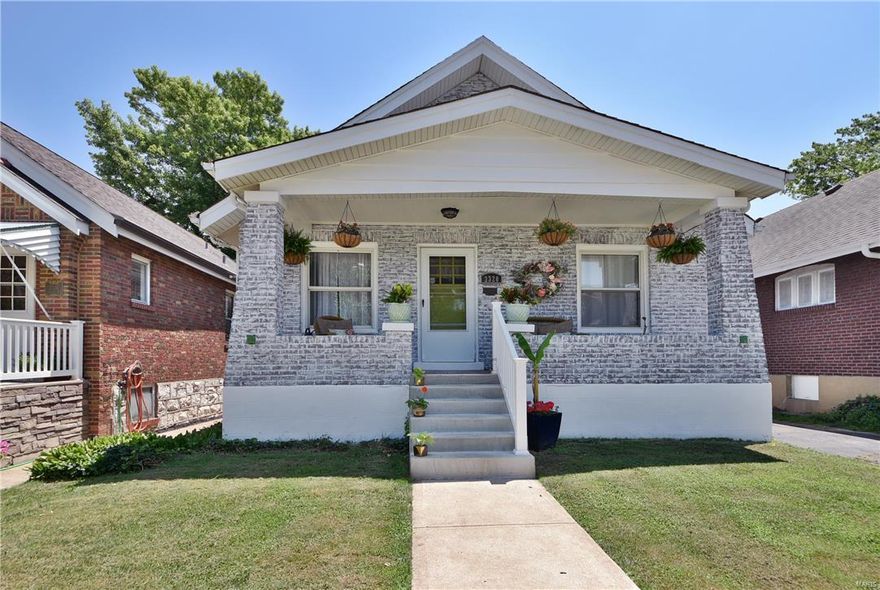 Prepare to fall in love with this charming 2 bed/2 bath all-brick bungalow, nestled in a quiet subdivision that is convenient to major hwys + all types of shopping & dining. Covered front porch welcomes you home & into the wide open adjacent living & dining rooms with handsome hardwood flooring providing ample space to greet & entertain guests. Kitchen has a ceramic tile half-wall & backsplash + stainless appliances & walk-out to the back deck overlooking the patio & level fenced-in yard. Hall bath has been thoughtfully updated including a contemporary granite top vanity along with decorative tile half-wall, shower surround & flooring. One of the bedrooms offers a staircase to the open attic lending tremendous storage space the entire length of the home. Enjoy expanded living space with the finished lower level adding a nice-sized family room with recessed lighting + a den/multi-purpose room & the 2nd full bathroom. New carpet to be installed in LL. Oversized garage w/ gated parking.