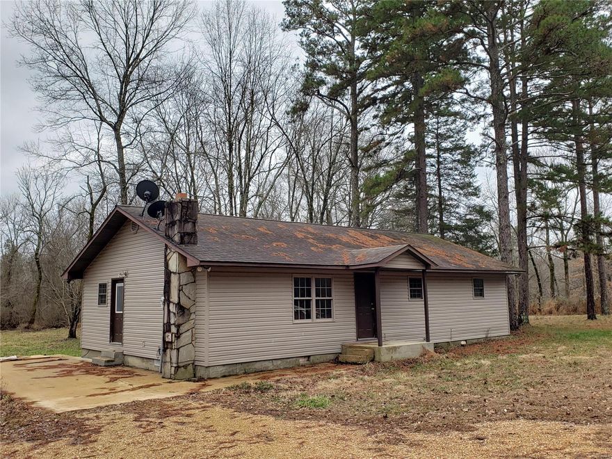 Want to get away? Escape to this 3 bedroom, 1 custom bath, open vaulted floor plan home in the woods. With the year round running water of Brushy Creek in your 2.3 acre back yard, you can always have somewhere to go to relax just a stone throw away. This property includes a deep well for the house, a 25 ft deep hand dug well for the fertile garden, and a 30x24 shop with an equipment lean to. Come purchase this beautifully shaded piece of property today.