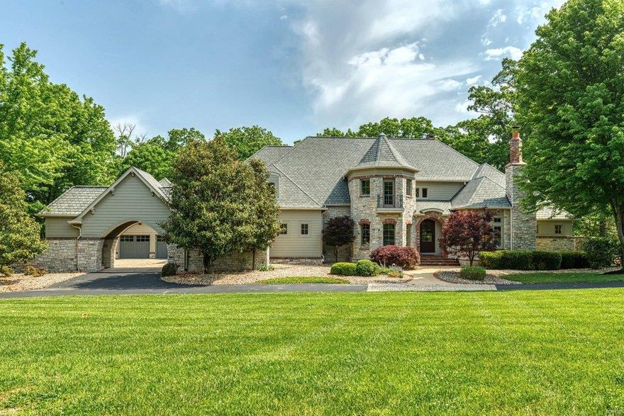 This magnificent 10,200 sf Estate home redefines luxury living. Impressive marble foyer leads to stunning 2-sty rotunda, paneled library with built-in bookcases & cast stone fireplace, elegant dining room & spectacular great room with wet bar & floor-to-ceiling stone fireplace. Designer kitchen featuring 42” pine cabinetry, granite countertops, commercial grade appliances & butler’s pantry adjoins breakfast room with convenient planning center & vaulted hearth room with rustic beam trusses & brick & stone fireplace. Coffered master bedroom suite radiates warmth with a see-through fireplace, sitting room & beautifully appointed bath that opens to private terrace. The 2nd floor extends the living quarters with 3 ensuite bedrooms, bonus room & 2nd laundry. Lower Level includes recreation room with 4th fireplace & wet bar, game room & media room plus office, 5th bedroom & 1½ baths. Situated on a wooded 1.4-acre lot with patio, grilling station & fireplace surrounded by landscaped gardens.