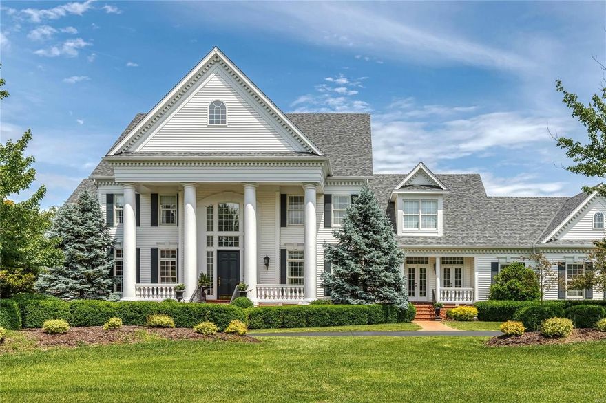 A truly magnificent Colonial in one of Town & Country’s most desirable neighborhoods! Grand 2-sty marble foyer highlighted by floating staircase leads to library-paneled study with box beam ceiling & built-in bookcases, elegant dining room framed by arched entryways & stunning great room with 2-sty palladian windows, marble fireplace with full-height mantel & wet bar. Designer kitchen featuring cherry cabinetry, granite countertops, commercial grade appliances, double islands & convenient planning center adjoins breakfast room with 2 sets of French doors & vaulted hearth room with floor-to-ceiling stone fireplace. Coffered master bedroom suite provides an appealing retreat with His & Hers walk-in closets & marble bath with fireplace, shower spa & Jacuzzi. Front & rear staircases access 4 additional bedrooms, 2 with ensuite baths & 2 with Jack n’ Jill bath. Outdoor living area includes wrap around deck & stone terrace surrounded by landscaped gardens plus circular drive & 4-car garage.