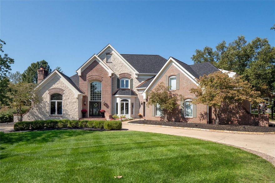 Luxury living awaits in this custom 1.5-story home with over 7,800 sqft, nestled on a quiet cul-de-sac with a private, tree-lined backyard and an inviting in-ground pool. The grand entry opens to formal spaces and an executive office with a fireplace. Perfect for entertaining, the home features a recently updated gourmet kitchen with Thermador appliances, a huge center island, and a vaulted hearth room. The great room offers built-ins, a walk-behind wet bar, and large windows with beautiful views. The main-level primary suite has French doors to a private deck and a spa-like bath with dual vanities, a walk-in shower, and two closets. The finished walk-out lower level includes a family room, wet bar, gaming area, workshop and more. Additional features include a newer roof, 3-car garage, main-floor laundry, deck, and circle driveway.