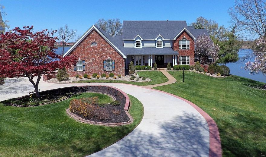 Undoubtedly one of the most famous homes in Lake Saint Louis!  This is the one everyone points to from their boat and Oohs and Awes over!  Located on the prestigious point of Eastern Shores with panoramic views of 600 acre Lake Saint Louis.  From your pool deck, hot tub, or private dock, watch the community fireworks or hop in your boat and go for a ski! Did we mention the spectacular sunsets? Located only 45 min from downtown and 25 min from Lambert International Airport, come live where you play and enjoy the resort lifestyle every day!  This 6700+ sq ft home sits on nearly an acre with over 200’ of gentle shoreline. From the high end kitchen to the 4 car garage, it has something for everyone.  Showings by appointment only. Additional Rooms: Mud Room, Sun Room