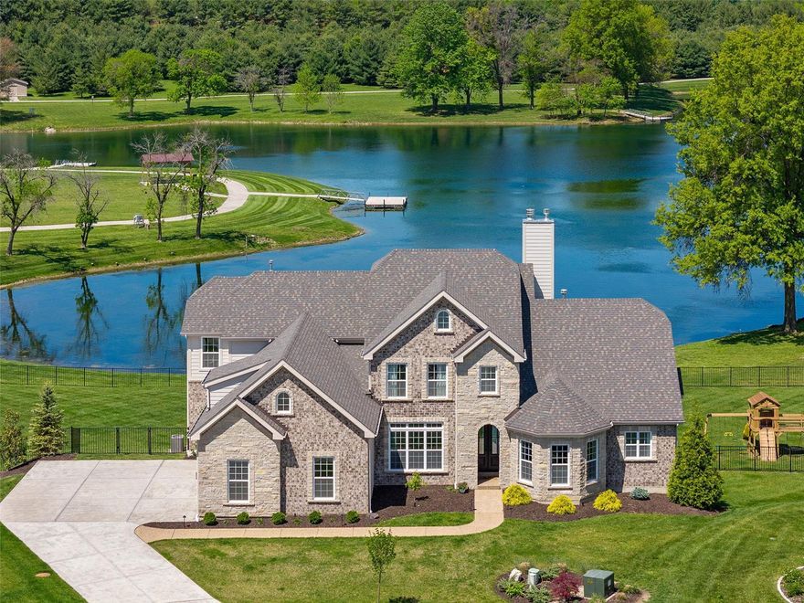 Enjoy livable luxury in this 6,500 sq ft stunner backing to the picturesque 26-acre neighborhood lake. Soaring 2-story great room w/impressive wall of windows showcasing breathtaking lake views. Those views are equally beautiful from the 4-season room, composite covered deck w/stone gas fireplace, & private primary suite w/composite martini deck. Chef's kitchen features soft-close 42" cabinets, quartz counters & Wolf stainless steel appliances. $300,000 was spent to professionally finish the walk-out lower level w/10' walls. It includes a rec room w/pool table, wet bar w/fireplace, home theater w/raised platform seating, star-studded ceiling, voice control, accent lighting, & soundproofed walls, home gym w/recovery room sauna, steam shower, & ice bath, office w/French doors, & secret/safe room behind the sliding bookcase. Spacious bedrooms w/private bath access & walk-in closets. Neighborhood pickleball courts, walking trail & much more. Amazing home! Unbeatable location! See it today! Additional Rooms: Sun Room