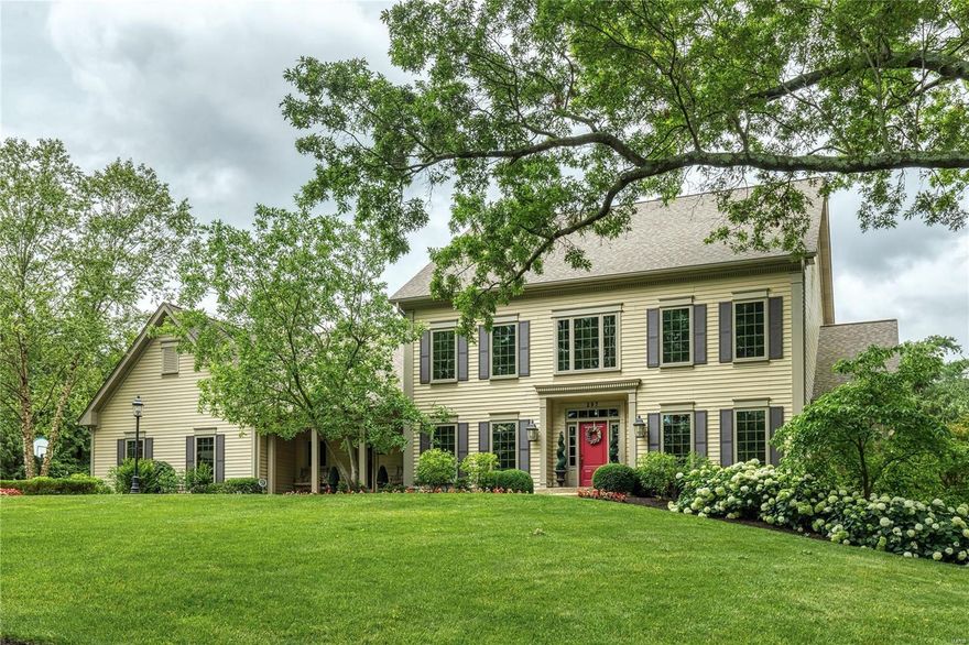 Classic 1.5-sty Colonial on parklike 1-acre grounds. Impressive 2-sty hardwood foyer opens to private study with built-in work center, formal dining room and stunning great room with box beam ceiling, architectural columns, wet bar & cast stone fireplace flanked by bookcases. Designer kitchen with 42” bisque cabinetry, granite countertops, premium appliances & 9’ center island adjoins light-filled breakfast room with French doors to patio. Coffered master bedroom suite with His & Hers walk-in closets, wide bay window & luxury bath with jetted tub offers an appealing retreat. The 2nd floor extends the living quarters with 3 additional bedrooms, 1 with ensuite bath & 2 with Jack n’ Jill bath. Walk-out Lower Level includes recreation room with see-through stone fireplace & family room with built-in entertainment center plus workout room, 2nd kitchen, 5th & 6th bedrooms, full bath & laundry.  Conveniently located along the desirable Ladue Road corridor. Award-winning Ladue School district.