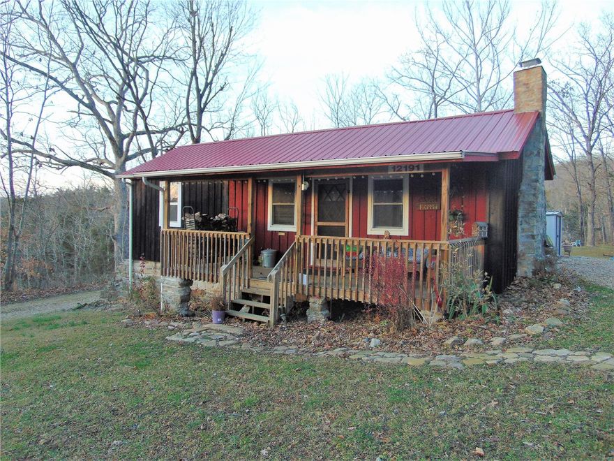 Absolutely adorable home snuggled into the forest on a dead-end road in historical Arlington. This home has been renovated and added on to within the last 7 years and features a Cabin feel with a cozy brick fireplace containing a wood insert. There is a nice large living room, eat-in kitchen, 3 bedrooms, and 2 full baths for plenty of space.  A Murphy bed in one bedroom is only one of the delightful features of this home. The kitchen has tile backsplash and built in shelves.  River access to the Gasconade for the Arlington township community homes adds so much to this property.  This home would make a perfect place to enjoy nature. $350.00 per year Assessment fee. See attached Association By-laws Article V section 5.01. Restrictions on file.  Don't miss this unique home, call today for an appointment!