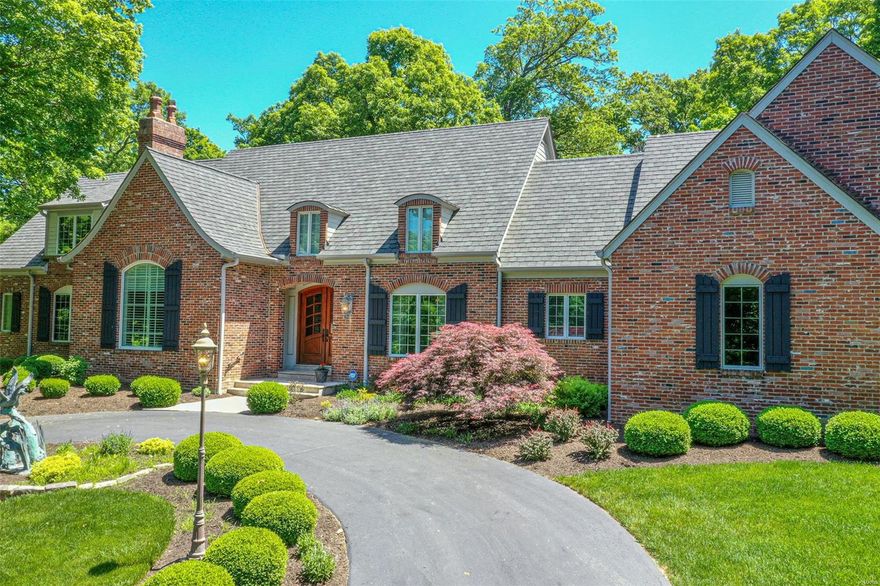 Exquisite 1.5 story brick home by Borzillo Homes in private enclave of custom-built homes features exceptional craftsmanship & upgrades galore! 4 bdrms,4 full baths & 3 half baths; Step-down Great Rm boasts 20’ cathedral ceiling, surrounded by ornate iron railing & gas stone FP; Gourmet Kitchen equipped w/6 eye Wolf gas range & custom hood, stone counters, 2 center islands, cabinet-faced refrigerator, & Brazilian cherry hardwood floors; ML Mstr Suite has tray ceiling, large walk-in closet & luxurious bath w/tub, walk-in shower & dual vanities; Hearth room, formal Dining Room, Office, and Laundry complete the ML. Divided UL extends living quarters w/3 add’l bdrms  each with ensuite bath; LL includes family rm w/half bath, dry bar, and large storage area with stair access to garage. Outdoor screened-in porch w/20’ vaulted ceiling and brick flooring; 3 car side entry garage. Easy access to Wildwood Town Center amenities. *Bronze Statues are NOT included in sale of the home.