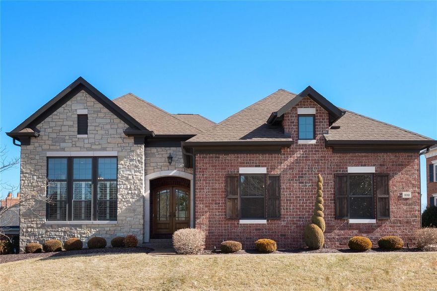 This stunning stone front home features elegance and quality. Arched entry doors ,office space, lofty ceilings, hardwood flooring, custom moldings, built-ins, light filled space and grand entertaining spaces throughout. Formal dining with impressive pillars and elegant chandelier. 2 story living room with gas fireplace opens into a large eat-in kitchen, massive quartz double edged island, chefs amenities and storage.  3 seasons room off kitchen; enjoy evenings relaxing under cover or out in the open on the composite deck. Main floor master with tray ceiling, his and hers walk in closets, and spa like ensuite bath.  Upstairs a landing area open to the living room overlooking the yard.  2 bedrooms with their own baths and walk in closets.  Downstairs bedroom, walk in closet, bathroom and more entertaining space with a fireplace and wet bar walks out to the backyard.  Walk the paths, sit and read at the reflecting pond & waterfall in this beautiful private gated community.