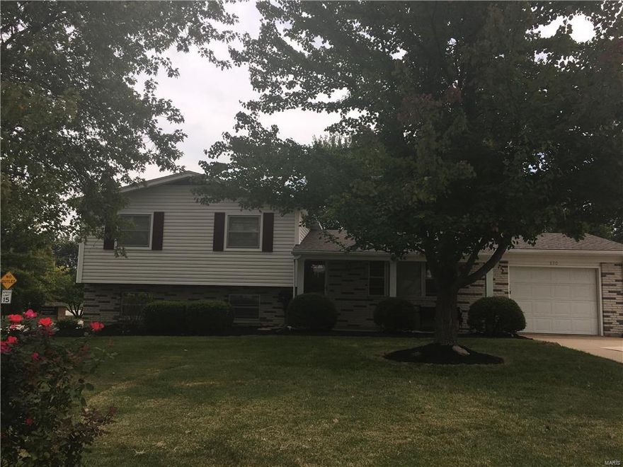 Nestled on a large corner lot with mature trees this home offers 3 bedrooms, 2 full baths, covered front porch, backyard patio, oversize 1 car garage with an extended driveway for additional parking and a utility shed.   A formal living room with new carpet and a nice picture window is on the main level along with a large eat-in kitchen. The kitchen comes with a refrigerator, gas range and dishwasher. The upper level has 3 bedrooms with a full bath. The lower level is a walk-out with a laundry room (washer to stay), large family room, full bath and new carpet.  This home has been given a fresh coat of paint and is move in ready!  Wentzville School District.