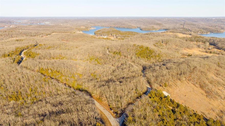 This impressive 21 +/- acre property offers a rare opportunity to embrace the natural wonders of the lake region with a public boat ramp just a minute down the road. Whether you're an outdoor enthusiast or seeking a peaceful retreat, this property is absolutely beautiful. Everywhere you turn you will be captivated by all the unique features this tract of land has to offer. An interior trail system invites you to wander through the gorgeous landscape, providing easy access to both sides of the property. Hunting enthusiasts will enjoy the abundance of wildlife, this property is a haven for deer, and turkey. You will also be able to utilize the conservation ground that is just a short walk off the property for even more hunting or exploration. Located just a stone's throw away from the Lake of the Ozarks and town amenities, yet secluded enough to enjoy the tranquility of rural living, this property offers the ideal balance of convenience and serenity. Schedule your viewing today!
