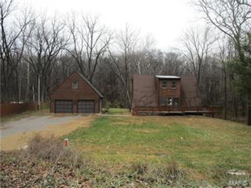 If you are looking for country living close to town, this property will appeal to you! Property could be used as single family home with detached apartment above garage or could be a multi family unit with 3 separate living areas. Main level has office or small bedroom, half bathroom, living room with many windows and fireplace, kitchen with attached laundry area, and dining room that walks out to one of the decks. Upstairs has one bedroom and loft area. Basement has kitchenette, family room, full bathroom, laundry area, and additional sleeping room. Two car detached garage with one bedroom apartment above the garage. The house is situated on private, wooded lot and has two decks to enjoy the country living!  Use caution when showing property-no utilities turned on. Home is being sold as is. Owner occupant offers for the first 15 days of the listing. 10 DAYS FIRST LOOK PERIOD. SpecialListingConditions: Foreclosure