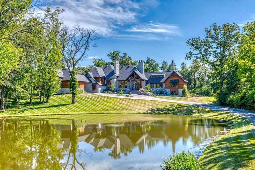 Soaring ceilings, oak hardwoods & timber beams define the rustic elegance of this 10,766 sf Bozich-built Estate home. Impressive foyer with groin vault ceiling & see-through fireplace opens to stunning great room with 16’ beamed ceiling & expansive windows, adjacent dining room & living room with stone accent wall & fireplace. Designer kitchen features quartzite countertops, 60” white cabinetry, commercial grade appliances, 10’ center island & butler’s pantry. Galley hallway leads to library-paneled study & primary bedroom suite with floor-to-ceiling fireplace, wet bar & beautifully appointed bath. A convenient office, guest suite & wine cellar complete the main floor living quarters.  Broad oak staircase accesses 3 additional ensuite bedrooms & bonus room. Lower Level includes recreation room, game room, media room, gathering bar, workout room & 1 ½ baths. Situated on 3+ wooded acres with outdoor living room with grilling station & fireplace, patio, stocked pond and 2 & 3-car garages. Additional Rooms: Wine Cellar