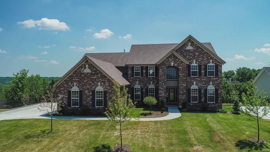 6-mo old, custom, 1.5-sty, by McBride Homes, on level lot. 4 bd / 3.5 bth, w/ 4212 sqft, open floor plan. Custom front door opens to 2-sty foyer, w/ chandelier. 1st floor has dining rm, great rm w/ wall of windows &  gas fireplace, brkft rm, eat-in kitchen w/ custom cabinets, granite counters, custom backsplash, island, brkfst  bar, planning desk, W/I pantry, & SS appliances & custom hood,  powder rm, laundry rm w/ custom cabinets & sink. Master has 2 W/I closets, w/ custom shelves & master bth has dual vanities w/ granite counters, separate shower, & soaking tub. Iron balusters line stairs to 2nd floor w/  balcony overlooking great rm, a bonus rm, Jack & Jill bth btwn 2 bds, 3rd bd w/ French Doors, & 2nd full bth. Other features: hardwood floors, zoned HVAC, full home filtration system, home sound system, alarm system, & 3-car garage. Deep pour walk-out LL could be finished bd, full bth, & rec rm, etc. Deck w/ panoramic views, level backyard. Great location.