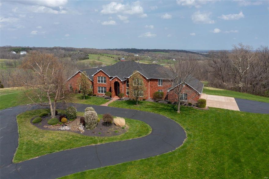 Set your appointment to view this incredible full brick, custom-built home right outside the Hannibal city limits, approx. 13,048 sq feet of living space, built on 72 acres, 4-10 car garage with a 40 x 60 outbuilding all this AND it comes with an indoor saltwater heated pool! 10' ceilings downstairs, 9 ' foot main, Surround yourself with total privacy with your locked gate private entrance, private drive winding through your incredible land to your mastiff circle drive at the front of your home!  Here you will enjoy the quiet life with water features, wildlife, woods space luxury & more. You have 15 different rooms,5 bedrooms and 6 baths with a finished lower level walkout, including a full bar with a wet sink, a man cave with a secret room, a gas fireplace with an extra bedroom, and another full bath! Dual stair maintenance-free deck with views for miles! If you're looking, this is the one!