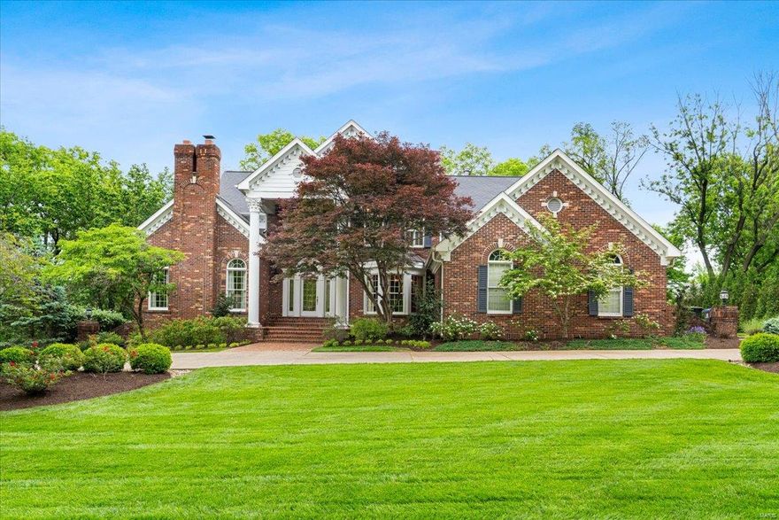 Set on nearly 1.5 acres in beautiful Frontenac, this custom home blends timeless elegance with modern comfort. The main-floor primary suite offers a marble bath and large walk-in closet. Formal spaces include a dining room with wainscoting and crown moulding, and a paneled den with built-ins and a woodburning fireplace. A soaring two-story living room is filled with natural light and rich architectural detail. The chef’s kitchen with large center island features Thermador and Sub-Zero appliances, two dishwashers, and custom wood cabinetry, flowing into a breakfast nook and hearth room with views of the lushly landscaped yard, stone patio, and classic pool. Upstairs are 3 bedrooms with walk-in closets and 2 full baths. The finished walk-out lower level offers a bar, fireplace, game room, exercise room, 5th bedroom, full bath, and glass-enclosed wine cellar. Designed with care and crafted with quality, this home offers exceptional living in one of the area's most desirable communities.