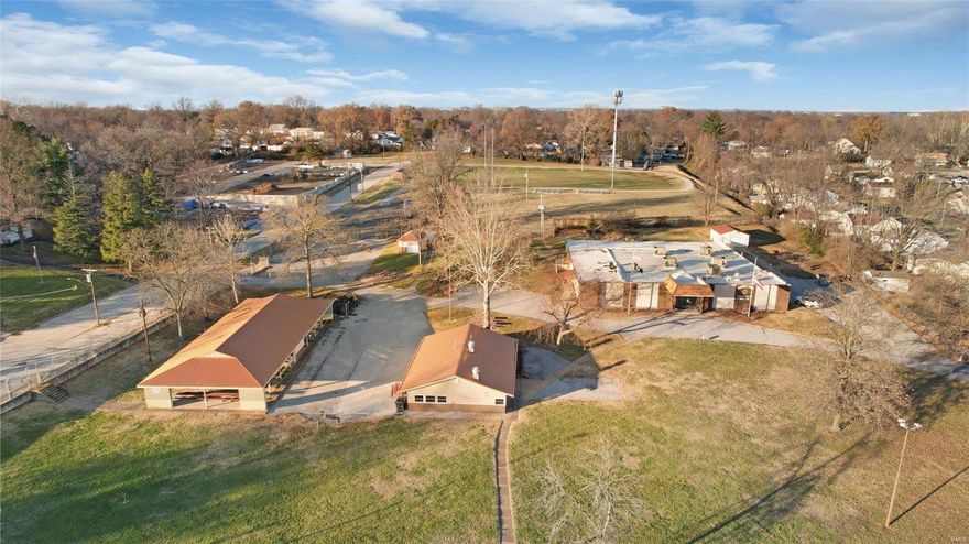 A Historic Landmark in Overland Missouri, Thoman-Boothe Post 338-American Legion Hall, is a fantastic opportunity for someone to  invest in a versatile property! Multiple buildings include an event center with over 13,000 sqft and capacity for 300, you'll find a large commercial kitchen, two bathrooms, office space, game lounge with private bathroom and tremendous storage. The 4.13 acres also includes a 2000 square foot building currently used as a concession/food service facility, a 5000 square foot pavilion with a concrete floor and newer metal roof. The grounds contain a separate garage for storage as well as a small building with men and women's restrooms. The entire 4.13 acres is fenced. Parking exists along Midland Blvd, a separate parking lot off of Angelo Avenue. There is an additional 1/3 acre available. So many possibilities for this property, with easy access to Lindbergh BLVD and Highway 170. Furniture, Fixtures and Commercial Kitchen Equipment may be available for sale. Some Accessible Features Location: City