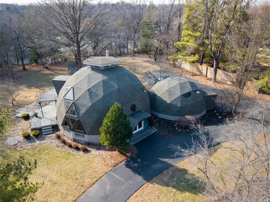 WOW! Built by engineer, Jon Mullinax, student of Buckminster Fuller, who invented and patent the geodesic dome. He also designed the Climatron at Botanical Gardens.  This one is Special! Unique, contemporary dome home with over 3,000 square ft. of living space seated on ONE FULL ACRE of beautiful scenery! Enjoy a gourmet kitchen featuring granite countertops, Sub-Zero Refrigerator, Dacor cabinets, custom lighting, wine cooler, Wolf warmer drawer and built in oven and microwave/convection oven, open to the dining room.  Master suite is full of light w/ large windows, built-ins, huge walk-in closet, private laundry and luxury master bath! Upstairs loft with 360 degree birds-eye-view perfect for an office, playroom or your own retreat. Walk out lower level with a media room, bath snd kitchenette.  From the expansive deck, overlook the gorgeous park-like acre. Easy highway access, close to Creve Coeur Park and Lake, and located in award winning Parkway schools, this home won’t last long.
