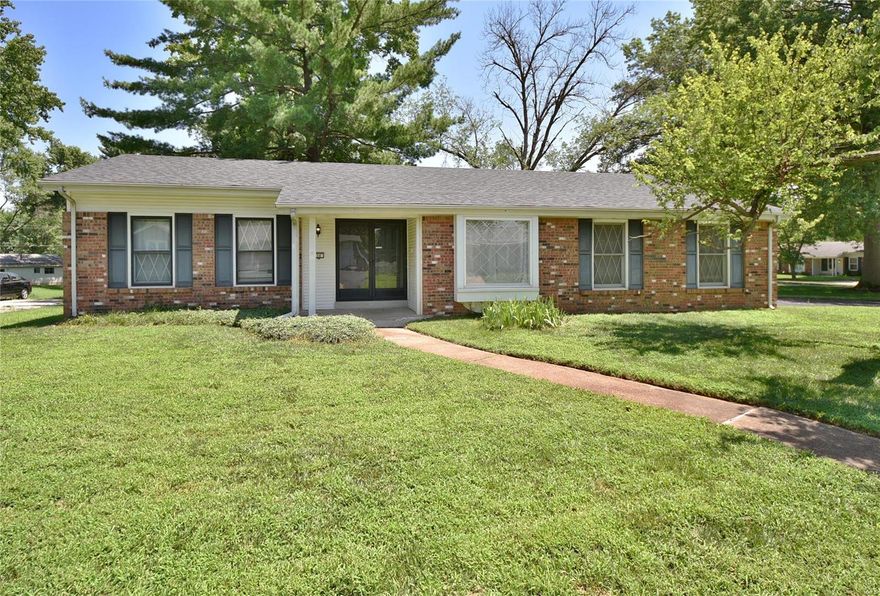 Nestled upon a large level corner lot with an ultra-convenient side-entry garage & long private drive, this terrific 3 bed/2 bath all-brick ranch is just what you've been searching for & more! The covered front porch welcomes you home & into the formal entry foyer that opens naturally into the large living room which includes handsome hardwood flooring that continues through most of the main floor lending a cohesive flow to the floorplan. Stretch out & relax in style with family & friends in the inviting family room with peg-n plank hardwood flooring, brick-surrounded fireplace & sliding glass walk-out to the patio. The family room connects to the dining room where you'll find exposed wood ceiling beams & the adjacent kitchen with ceramic tile backsplash & a second walk-out to the back yard. Retire in comfort to the main floor master suite with a private full bathroom. The LL includes a private den & potential for further finishing. Treat yourself with an Appointment Today!