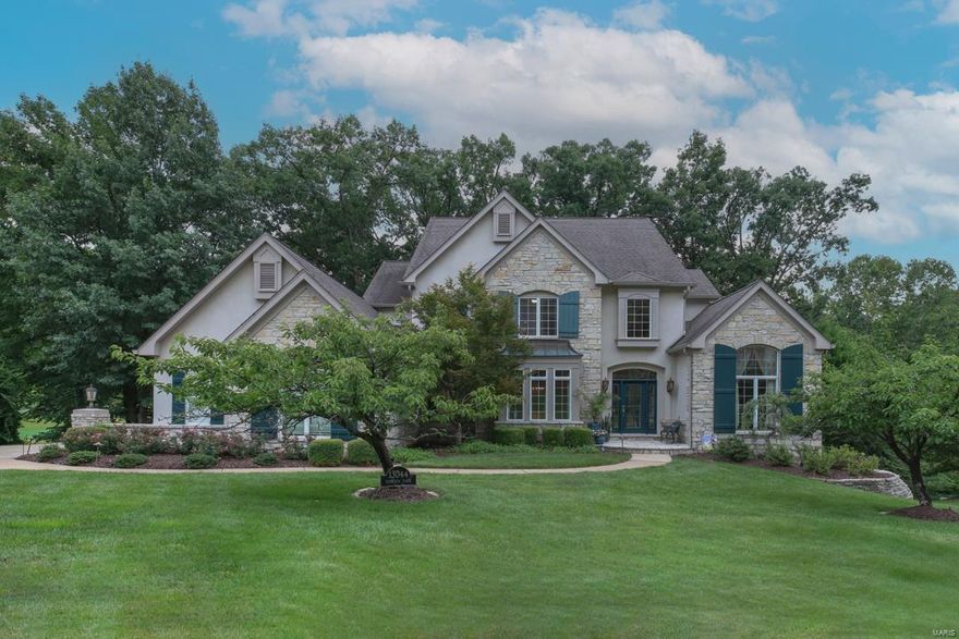 Stunning 1.5-Story on a beautiful .95-acre wooded lot, backing to the 1st hole, in the sought after Tapawingo Place Subdivision. 4 Bed/4.5 Bath & 6200+ sqft of living space! Main Floor boasts: formal Dining Room, vaulted Study/Den with custom built-ins; an amazing 2-Story Great Room with wall of windows, FP & wet bar. Gourmet Kitchen with custom cabinets, top-tier granite, breakfast bar, top of the line appliances, walk-in pantry & Butler’s pantry, Breakfast Room with beverage bar. Vaulted Hearth Room with stone FP; Main Floor Laundry! Master Retreat with deep coffered ceiling, dual custom walk-in closets & luxury Bath with jetted tub. 2nd Floor finds: Juliet balcony, Loft area with workstation, 3 add’l Beds, 1 en-suite, the other 2 share a Jack & Jill Bath. Professionally finished, walkout LL includes large Rec Room, wet bar, Bonus Room & the 4th full Bath. Relax on the expansive rear deck, leading to screened-in gazebo/treehouse & huge covered porch. Perfect home for entertaining!